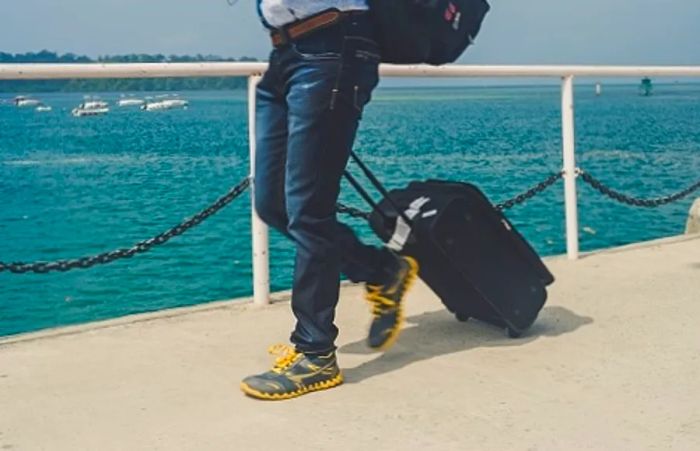 man preparing to board a cruise ship at the cruise port with his luggage