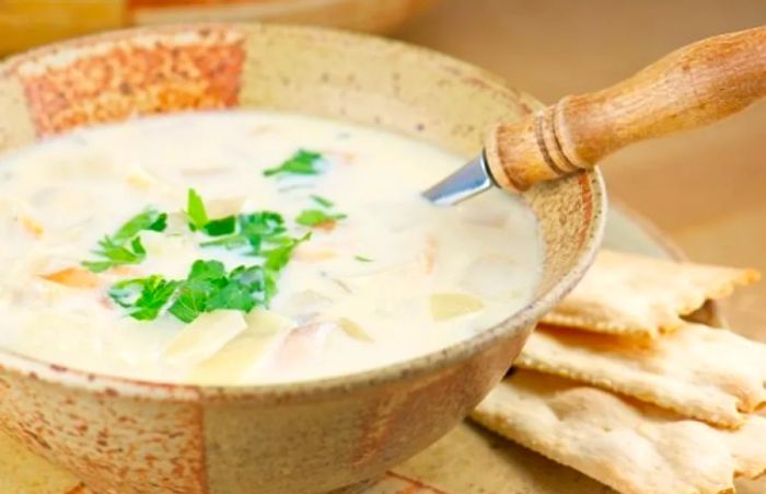 fish chowder served in a wooden bowl alongside crackers