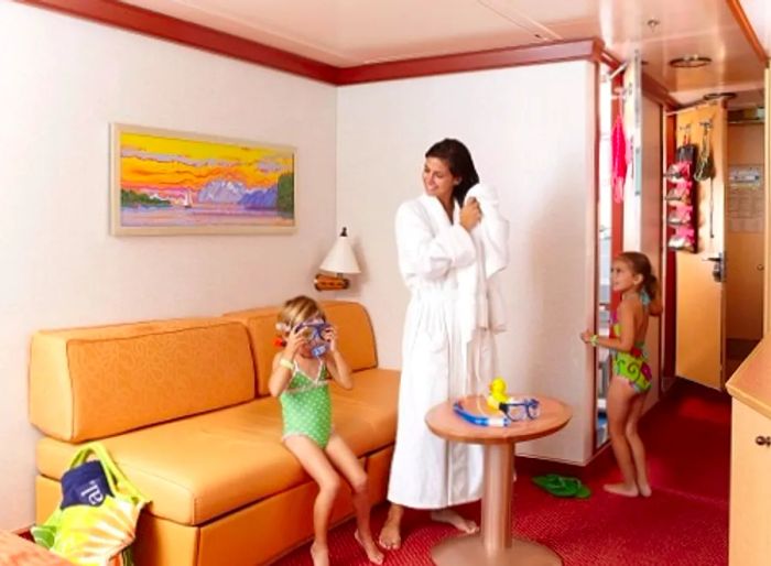 a mother and her two daughters in their stateroom preparing to head to the onboard pool