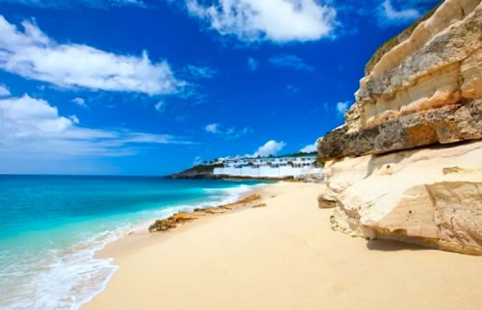 the pristine white sand beach and cliffs of St. Maarten