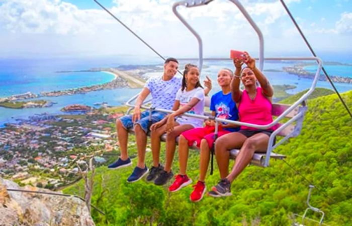 Siblings capturing a selfie as they ascend the Sky Explorer in St. Maarten.