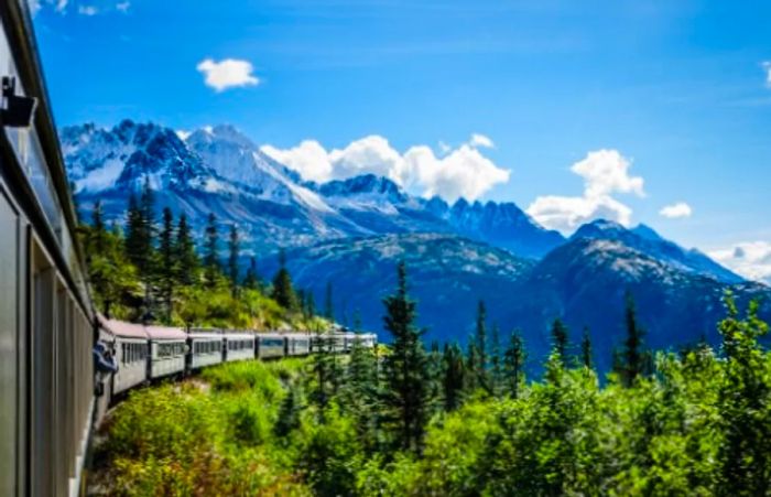 A scenic view of the Yukon landscape from a train as it travels towards the White Pass in Skagway