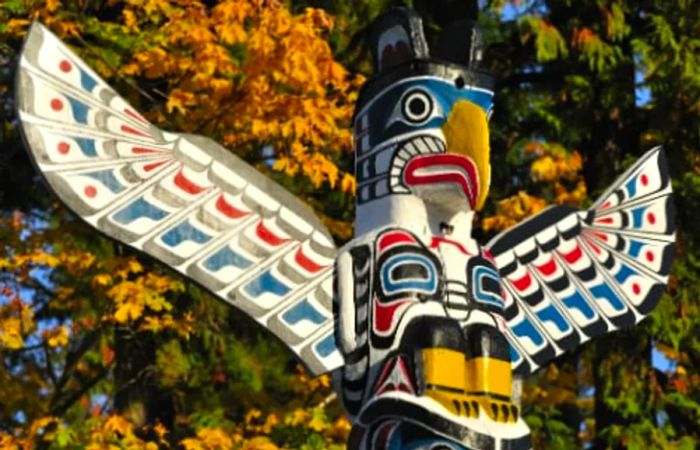 a vibrant, wooden totem pole crafted in Victoria, British Columbia