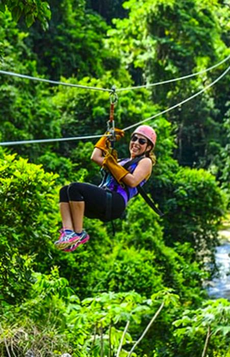 woman enjoying herself while zip lining in la romana