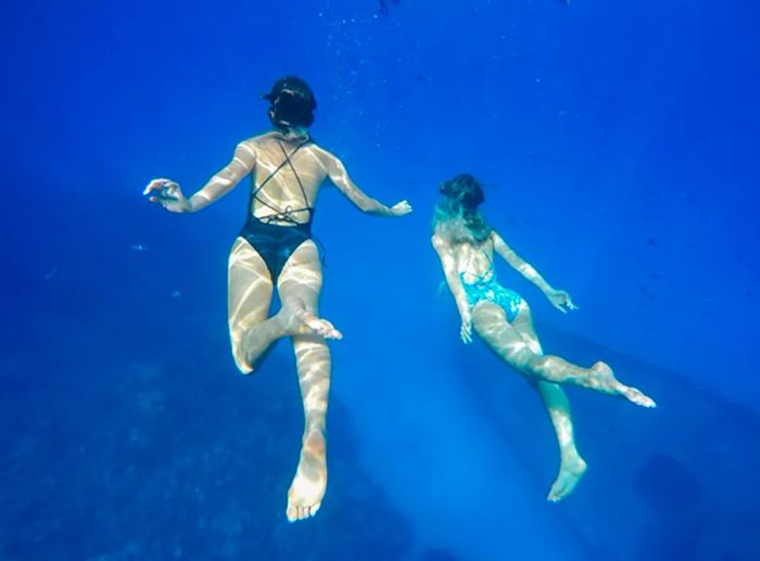 Tess & Sarah snorkeling underwater at the USS Kittiwake