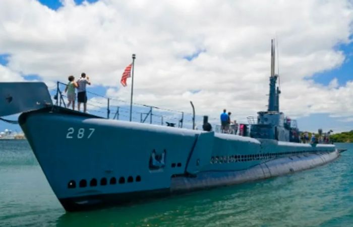 A tourist touring the USS Bowfin submarine SS287 during a museum visit in Hawaii