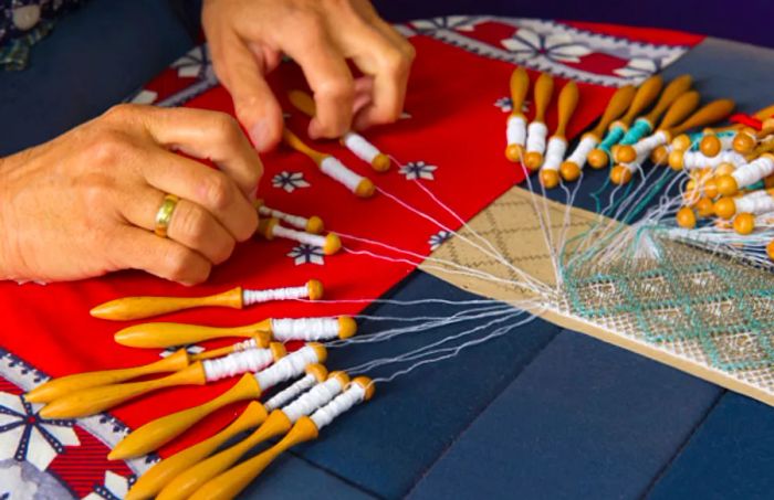 woman crafting a blue and white mundillo by hand in san juan