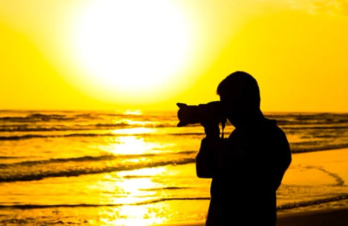 a person capturing breathtaking sunset photos on a Bonaire beach