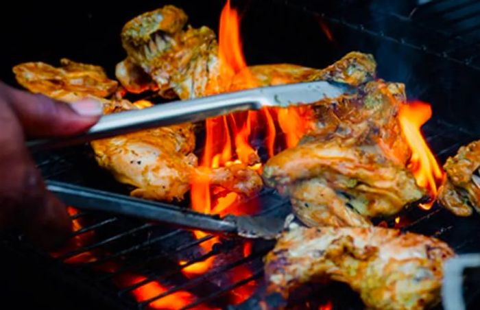 jerk chicken from Tortola being grilled over an open flame