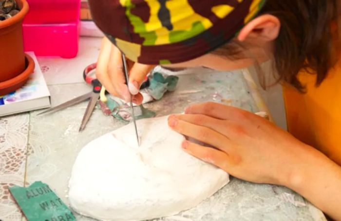 man crafting vejigante masks by hand in san juan