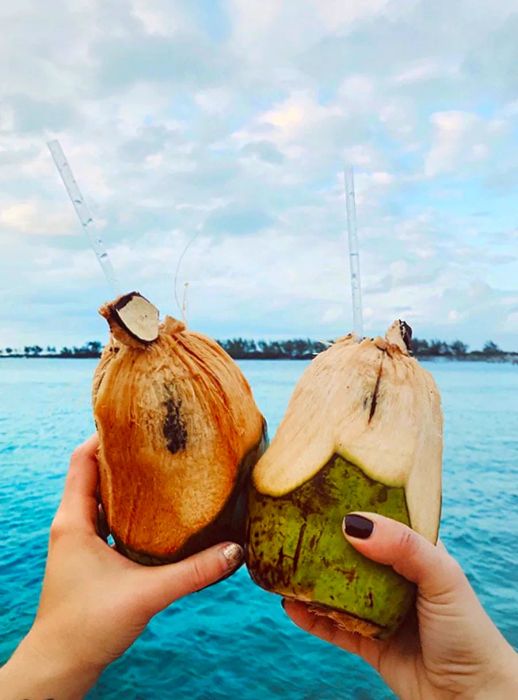 Cheers with coconuts over the water