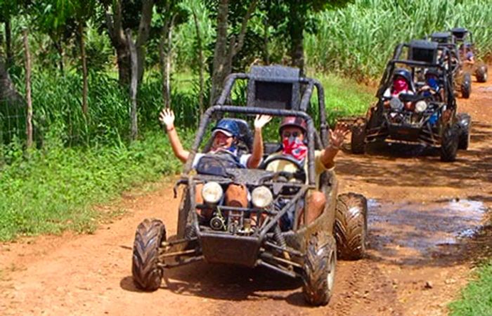 groups of people driving dune buggies through muddy trails in the Dominican Republic