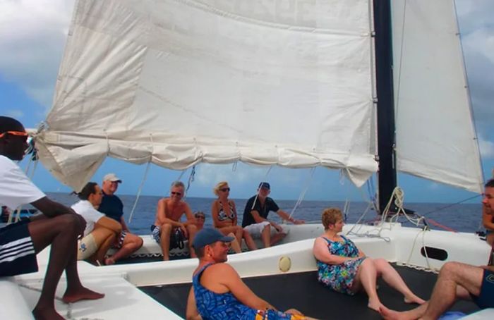 tourists enjoying a sailing trip on a catamaran, soaking in the scenic views of Grenada