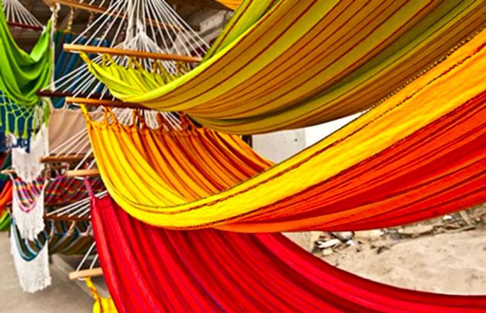 vibrant yellow, green, and red hammocks available in Limón