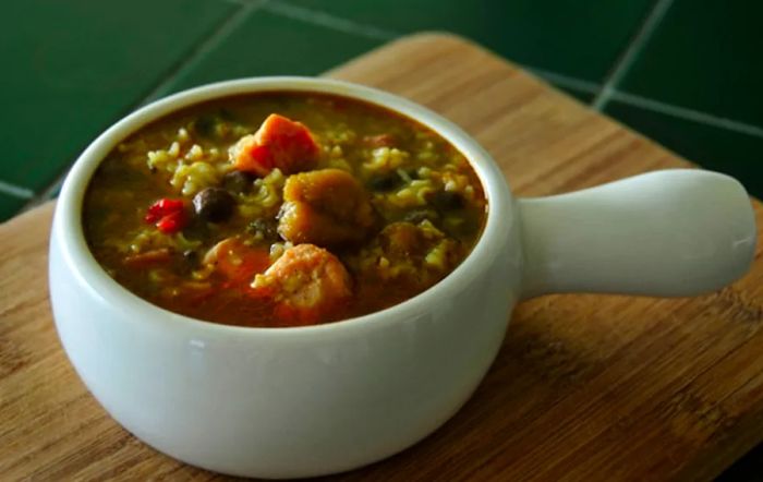 Dominican asopao featuring rice and chicken, served in a white bowl