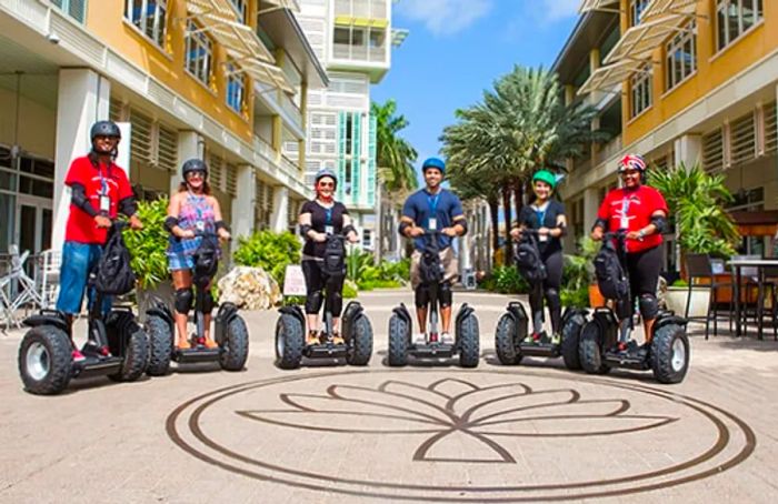 a group of people riding Segways while exploring Grand Cayman