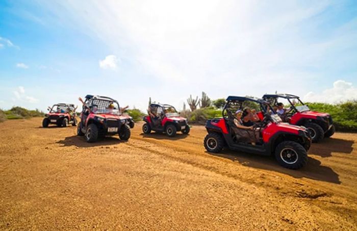 group of adventurers driving mini Jeeps along Curacao’s northeast coast