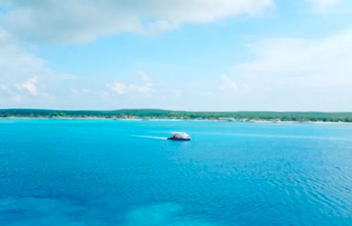 A glimpse of a small boat bobbing in the ocean