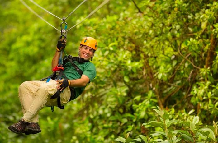 Man zip-lining through the forest in St. Kitts