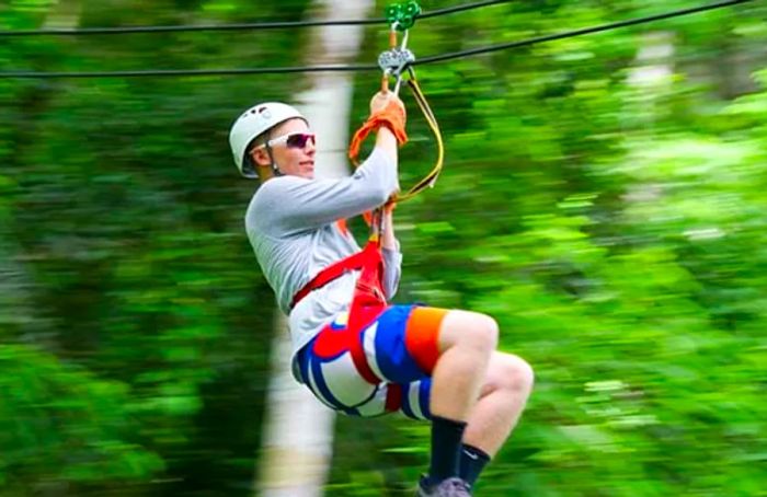 man ziplining in belize