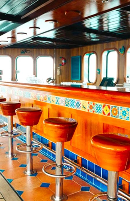 Vacant, vibrant barstools awaiting guests