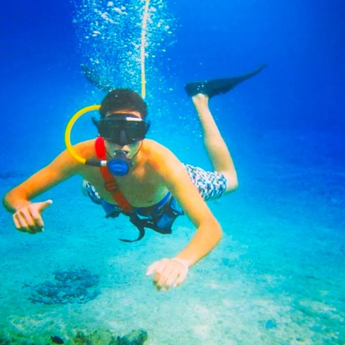 A man enjoys snuba diving in the ocean off the coast of St. Maarten