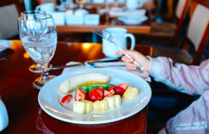 Drea’s daughter enjoying a fruit-filled breakfast