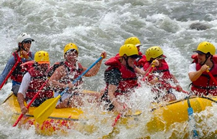 adventurers white water rafting through the thrilling rapids of the Reventazon River