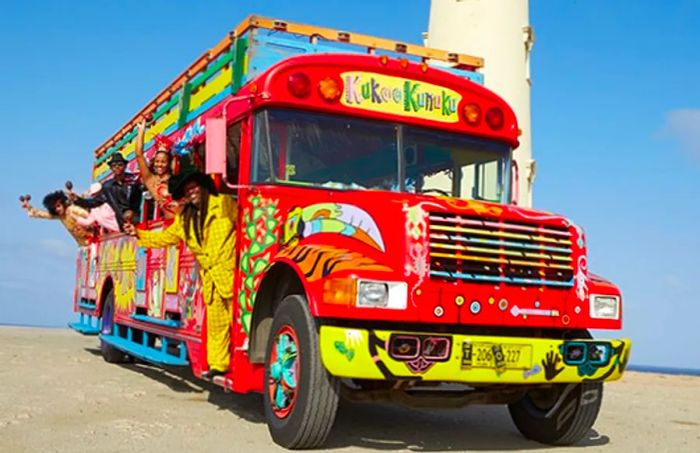 a tourist enjoying a ride on the Kukoo Kunuku open-air bus in Aruba