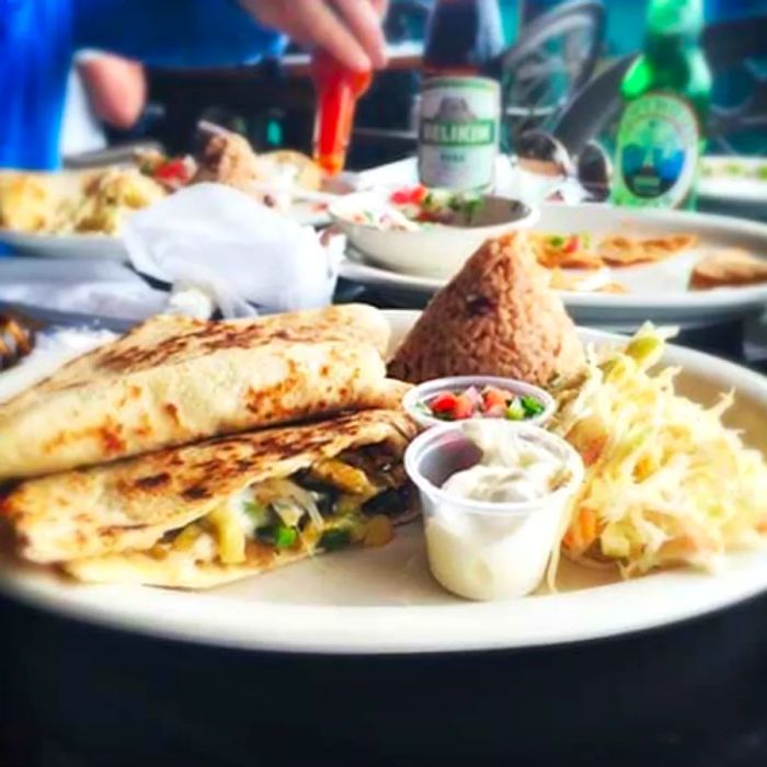 A plate featuring quesadilla, rice, and sides in Caye Caulker, Belize