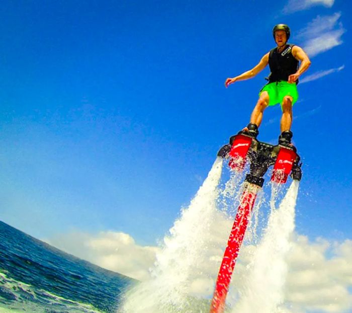 a man leaping out of the water on a flyboard in St. Thomas