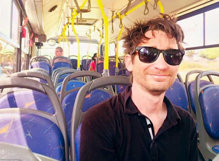 Randy sporting sunglasses while riding a bus in Aruba