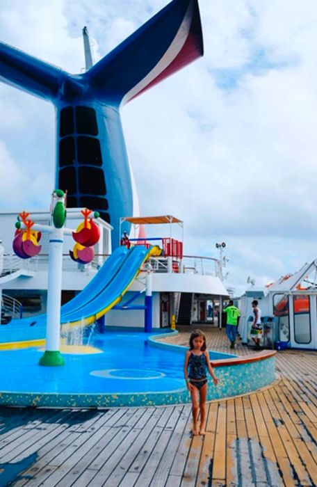 Drea’s daughter with the waterslide and the Dinogo fin in the background