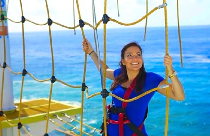 a woman navigating the ropes course