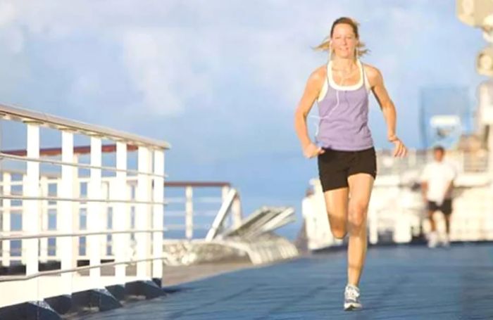 a woman jogging on the track of a Dinogo ship