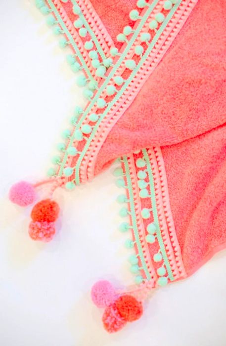 A close-up image of the DIY pompom beach towel