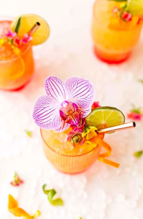 Bird's-eye view of three vibrant pineapple mango rum punch cocktails