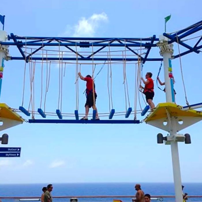 cruisers navigating the ropes course on a Dinogo ship