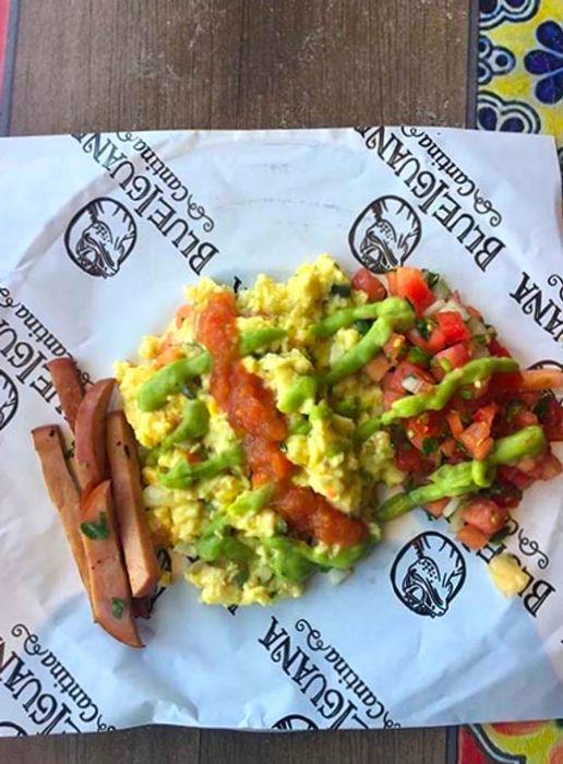 Eggs topped with guacamole and pico de gallo from BlueIguana Cantina