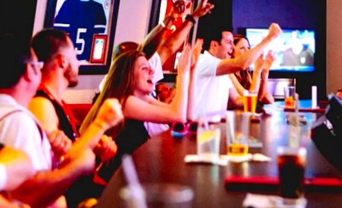 a lively crowd enjoying a game at the SkyBox Sports Bar