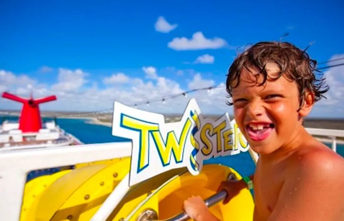 a young boy preparing to slide down the Twister Waterslide