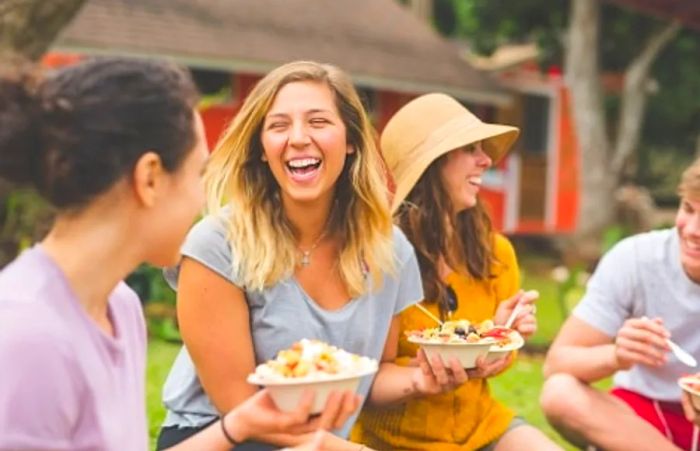 friends enjoying traditional Hawaiian dishes during their cruise vacation