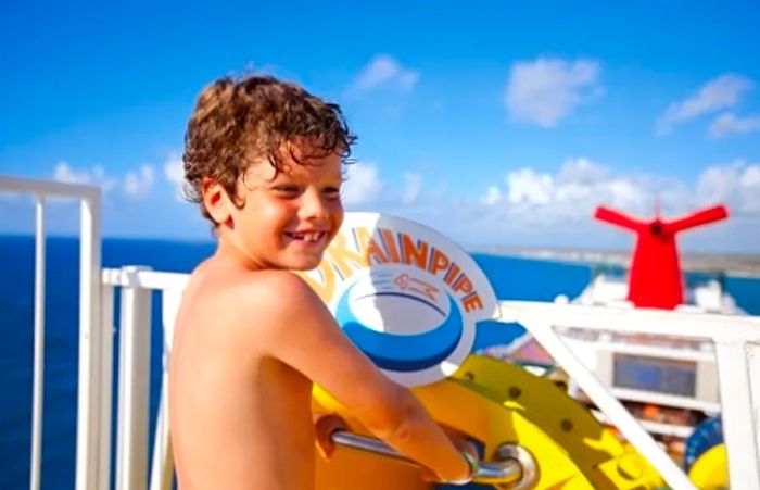 A boy preparing to slide down a water slide at the WaterWorks on Dinogo Dream