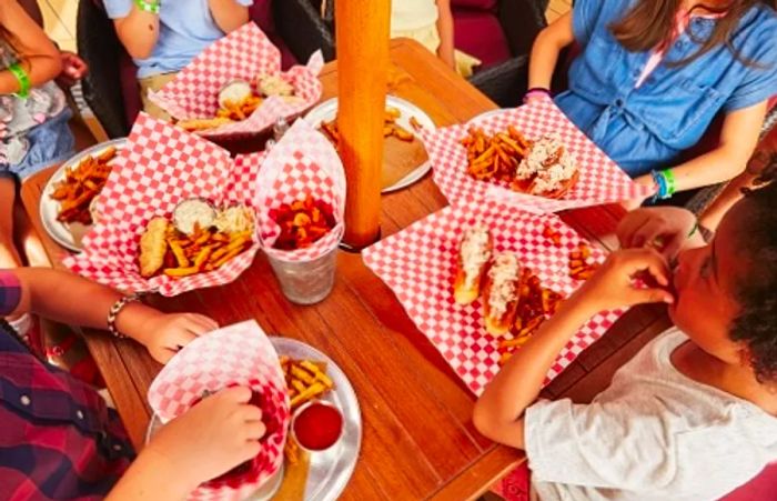 a family enjoying lobster rolls from Seafood Shack