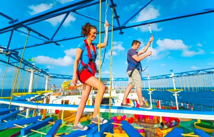 A couple navigating their way through the ropes course