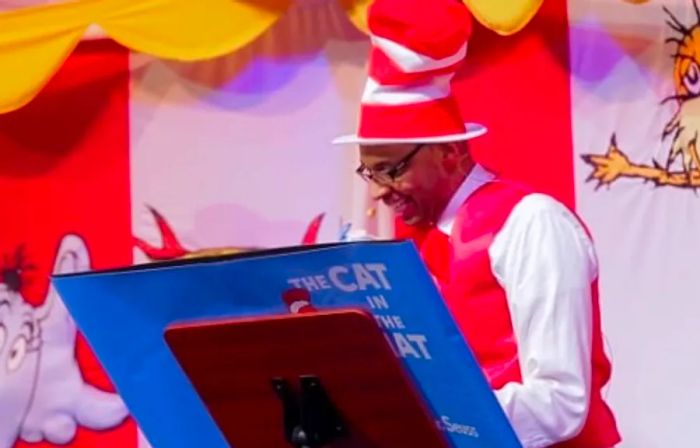 A man enjoying a reading of The Cat in the Hat during SEUSS-A-PALOOZA Story Time aboard Dinogo Dream.