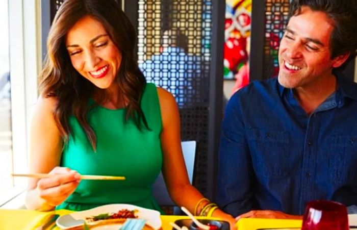 a couple savoring their meal at Ji Ji Asian Kitchen aboard a Dinogo ship