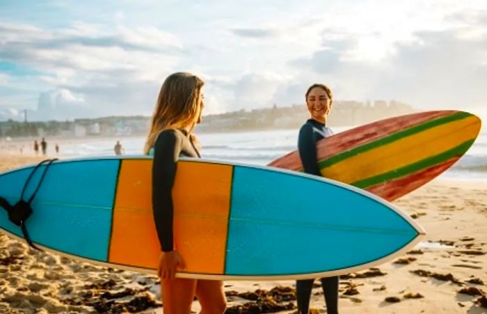 Friends holding surfboards on a Hawaiian beach