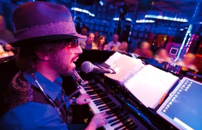 a pianist serenading guests at the Piano Bar