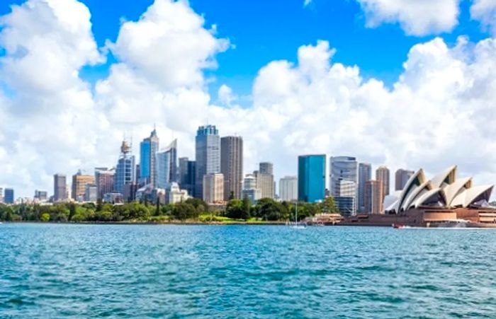 a panoramic view of the Sydney city skyline featuring the Sydney Opera House